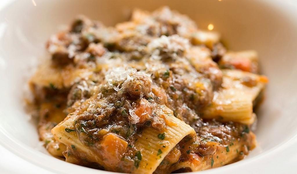 Paccheri alla Genovese · Torchio pasta with a slow-cooked, 8-hour braised sweet onion and flank steak ragu.