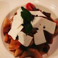 BUCATINI CON BROCCOLI · Thick hollow spaghetti with cauliflower-saffron ragù, pine nuts, pecorino, raisin & topped w...