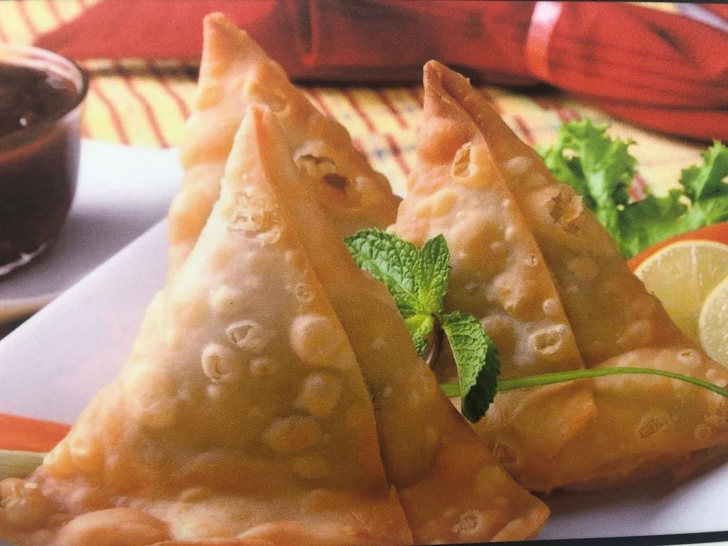 Samosa · Crispy pastry filled with potatoes, peas and spices come with tamarind and mint sauce 