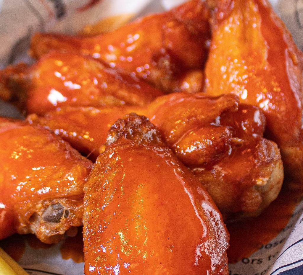 Wings · Cooked wing of a chicken coated in sauce or seasoning.