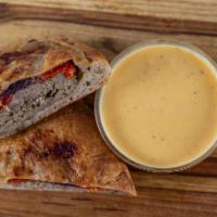 Patty Melt Calzone · Burger patty with mozzarella, caramelized onions, & roasted tomatoes, ranch to dip