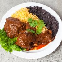 Mole Poblano · Chicken topped with mole sauce. Served with rice, beans and home made tortillas.