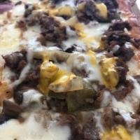 Philly Cheesesteak Pie · Thin sliced steak, peppers, mushrooms, onions, and cheese.