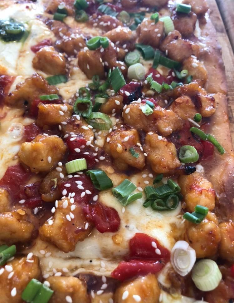 General Tso's Pizza · Tender bites of chicken in a slightly spicy Tso’s sauce topped with scallions and sesame seeds.