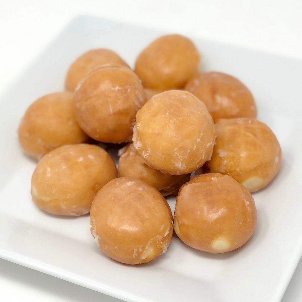 Dozen Donut Holes, Glazed · The center is the best part! Glazed donut holes packed by the dozen and there's no harm in licking your fingers afterwards!