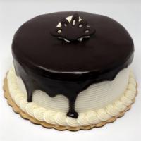 Tuxedo Dessert Cake · Chocolate cake with white buttercream filling and icing with ganache waterfall on top. A per...