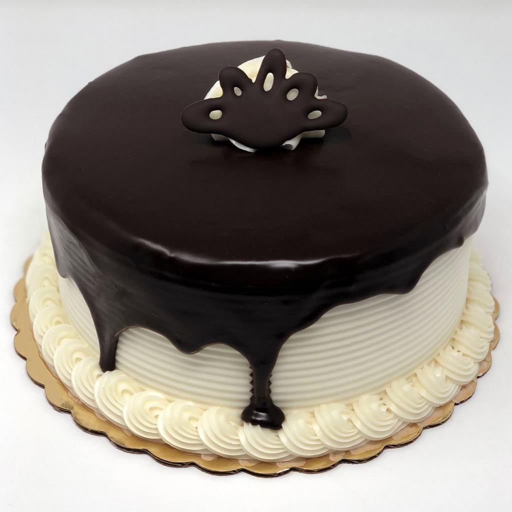 Tuxedo Dessert Cake · Chocolate cake with white buttercream filling and icing with ganache waterfall on top. A perfect chocolate and vanilla combination!
