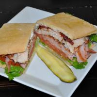 Merritt's Club Sandwich · Ham, turkey and bacon with lettuce, tomato and red onion with mayo on delicious ciabatta bre...