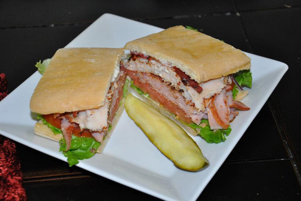 Merritt's Club Sandwich · Ham, turkey and bacon with lettuce, tomato and red onion with mayo on delicious ciabatta bread.