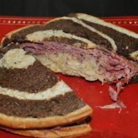 Reuben Sandwich · Stacks of sliced corn beef, Swiss and sauerkraut with Thousand Island dressing on grilled ma...