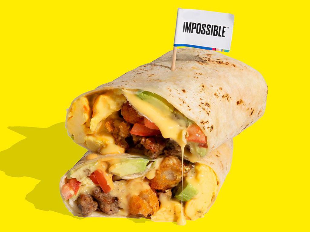 IMPOSSIBLE™ BREAKFAST BURRITO · Wake up and smell the sausage! This burrito has it all! Crumbled Impossible™ Sausage Made From Plants & plant-based egg, crispy tater tots, tomatoes, avocado, plant-based cheese sauce & chipotle crema wrapped in a warm tortilla