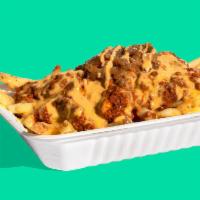 THE SHOP CHILI CHEESE FRIES · Step up your fry game with Impossible™ Chili & plant-based cheese sauce-smothered fries with...