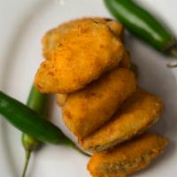 Jalapeno Poppers · Jalapenos with melted cheddar cheese fried to a golden crisp.
