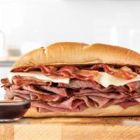 Brisket Bacon N' Beef Dip Sandwich · Sliced smoked beef brisket and roast beef with melted Swiss cheese, and pepper bacon on a to...