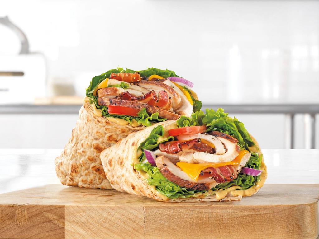 Market Fresh® Chicken Club Wrap · Slow roasted chicken breast with natural cheddar cheese, green leaf lettuce, red onion, honey mustard sauce, and tomato in an artisan wheat wrap.