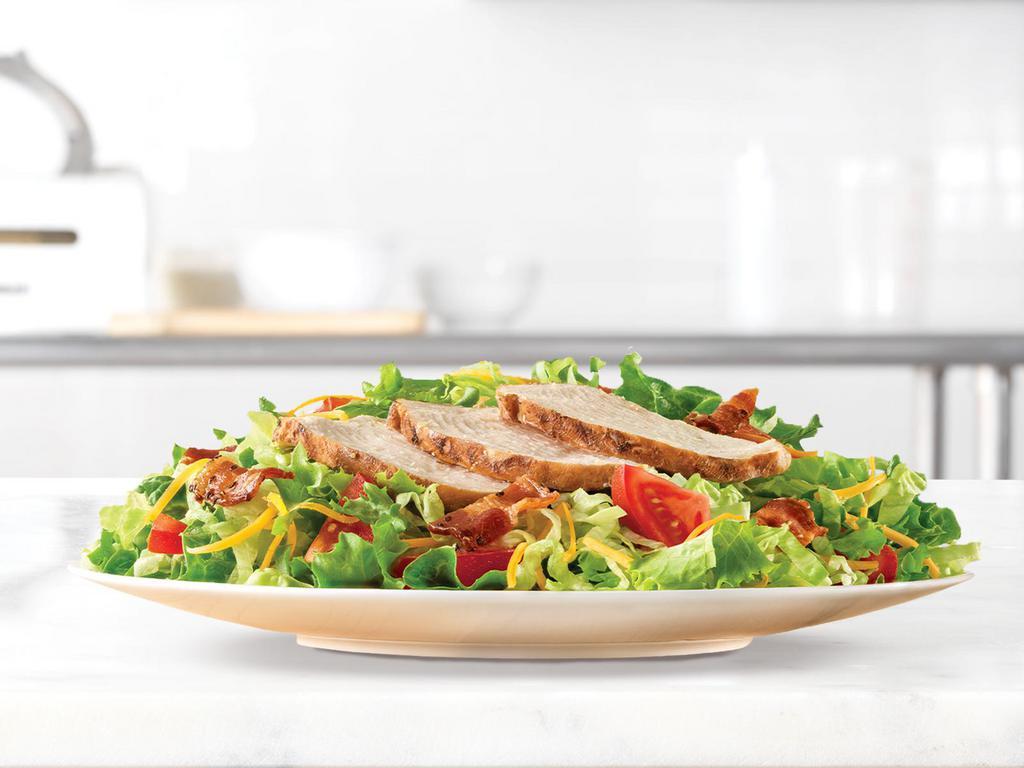 Roast Chicken Salad · Slow roasted chicken and diced pepper bacon on a bed of chopped fresh lettuce with diced tomatoes and shredded cheddar cheese. Served with choice of dressing.