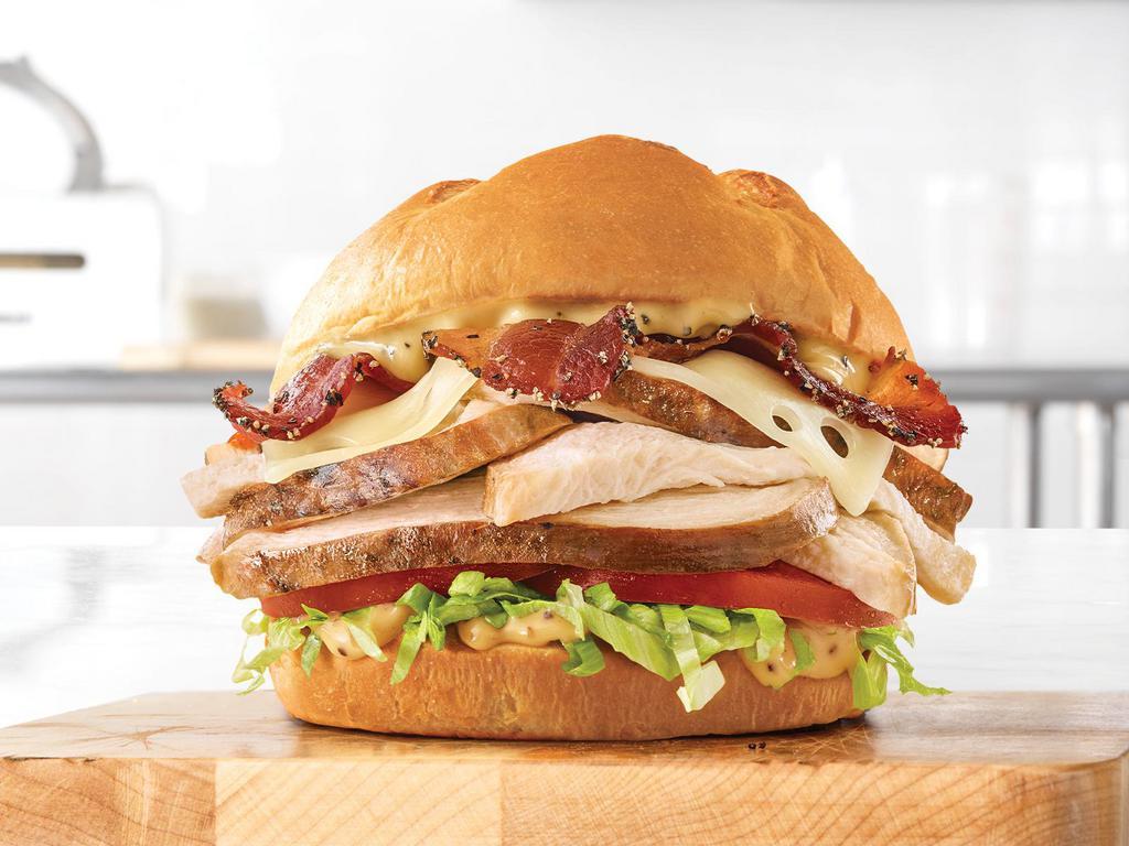 Roast Chicken Bacon & Swiss Sandwich · Slow roasted chicken with pepper bacon, Swiss cheese, lettuce, tomato, and honey mustard on a toasted specialty bun.