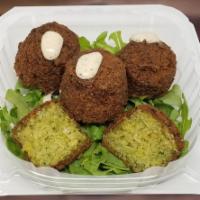 4 Falafel · Ground chickpeas, garlic, onion, & parsley formed into a ball & deep fried. Served with humm...