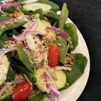 Spinach Salad · Our NEW Spinach salad topped with cucumber, grape tomatoes, red onion, shredded parmesan, su...