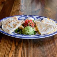 Quesadillas · Mexi-queso, sauteed onions and peppers, crema, guac, pico de gallo, and chipotle-spiced ranc...