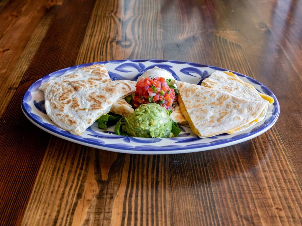 Quesadillas · Mexi-queso, sauteed onions and peppers, crema, guac, pico de gallo, and chipotle-spiced ranch. Add-ons for an additional charge.