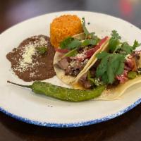 Asada Tacos · Ancho- rubbed ranch steak, pickled red onion, roasted poblano, chile del arbol, and asadero ...