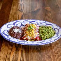 Enchiladas Rojas · braised beef short rib, Cotija cheese, cilantro, onion, and red chili, and chile guajillo sa...