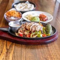 Fajitas · Mesquite grilled, served sizzling with grilled onions, bell peppers, frothy garlic butter. A...