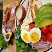 Cobb Salad · This traditional cobb has avocado, cherry tomatoes, red onion, hard-boiled egg, bacon, Gorgo...