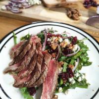 Flank Steak Salad · This salad has candied walnuts, dried cranberries and Gorgonzola on arugula, topped with gri...