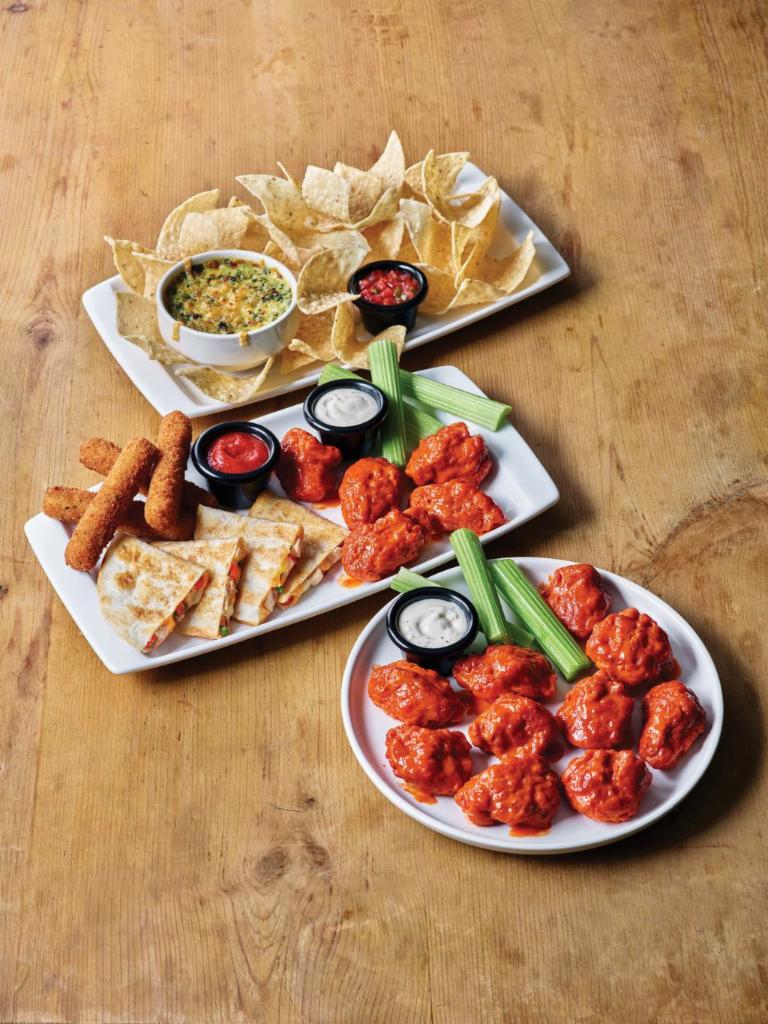 The Classic Combo · All the classic apps you love on one plate - Boneless Wings, Spinach and Artichoke Dip, Chicken Quesadilla and Mozzarella Sticks.