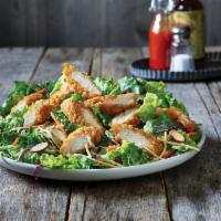 Oriental Chicken Salad · A long-running favorite, crispy breaded chicken tenders top a bed of Asian greens, rice nood...