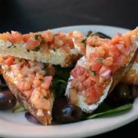 Bruschetta · Marinated tomatoes ,chopped red onions served on a goat cheese crostini