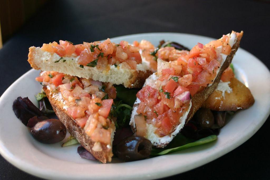 Bruschetta · Marinated tomatoes ,chopped red onions served on a goat cheese crostini