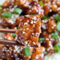 S5. Sesame Chicken · Chunks of chicken with brown sauce and broccoli with sesame seeds on the top. Served with ch...