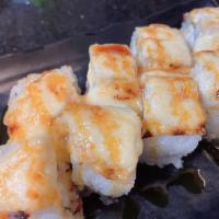 Snow Corn Roll · Crab meat and avocado inside,  white fish baked with dynamite sauce on the top 