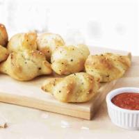 Garlic Parmesan Knots · 8 pieces. Made with fresh baked dough and garlic Parmesan seasoning. Served with pizza sauce...