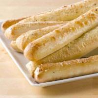 Garlic Parmesan Breadsticks · Oven-baked dough topped with special garlic sauce and Parmesan Italian seasoning.