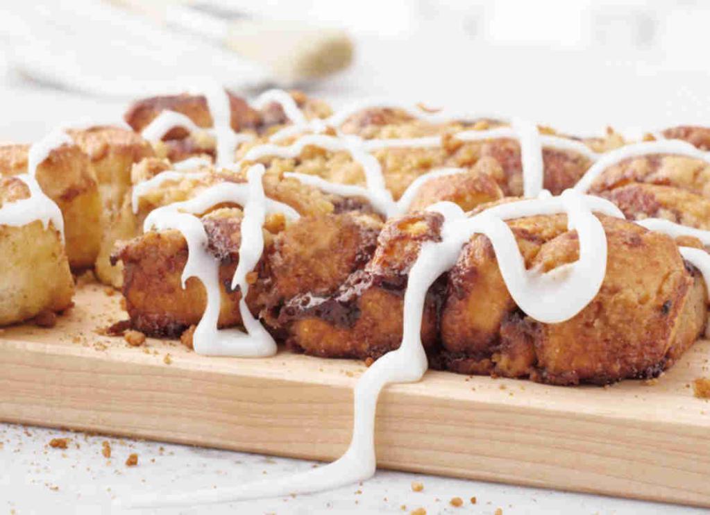 Cinnapie · Fresh, oven-baked dough topped with cinnamon or apple filling, brown sugar streusel and and white icing.