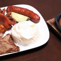 Typical Colombian Dish Plate · Rice and beans, grilled steak, pork loin, fried egg, corn cake and sweet plantains.