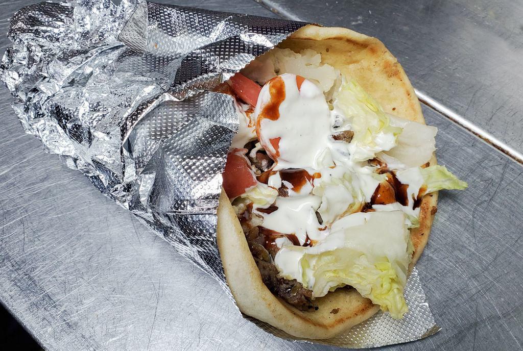 Lamb Gyro · Slow-cooked lamb on a pita served with lettuce, tomatoes, onions, and your choice of sauce.