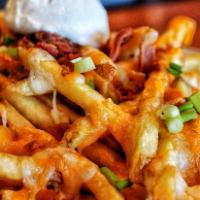 Smothered Cheddar Jack Fries · Piled with bacon, cheddar Jack cheese blend, sour cream, and chives served with homemade ran...