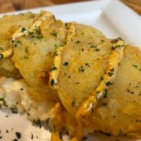 Fried Green Tomatoes · 4 fresh green tomatoes hand-breaded and fried, served over stone-ground cream cheese grits w...