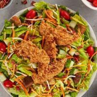 Calabash Chicken Salad · Calabash chicken on mixed greens with carrots, cucumbers, tomatoes, smoked bacon, Monterey J...