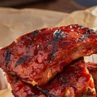 Baby Back Ribs · Our fall-off-the-bone ribs in the housemade sauce of your choice served with a side of fries...