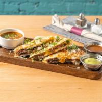 Barrio Birria Quesadilla · Slow cooked lamb barbacoa, queso fresco, oaxaca cheese, chihuahua cheese, white onion, guaca...