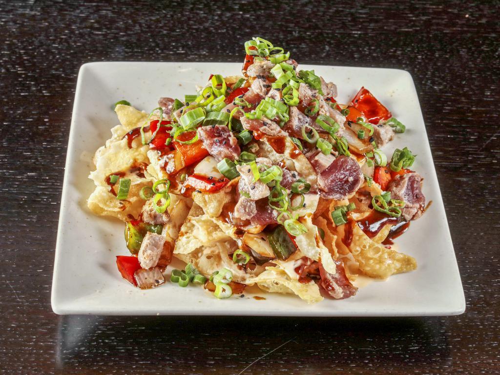 Tuna Nachos · Crispy wonton with seared tuna, bell peppers, onion Sriracha Aioli, & hoisin.