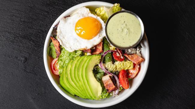 Side The Cobb (gf) · Organic baby greens, smoked bacon, blue cheese, organic sunny side egg, avocado, organic grape tomatoes, organic red onions, green goddess.