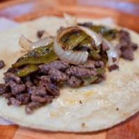 Guanajuato Taco · Sirloin steak, grilled onions and green chili over handmade corn tortilla. Sirloin steak a l...