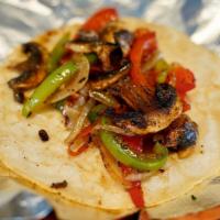 Vegetariano Taco · Seasoned grilled bell peppers, onions, and mushrooms over handmade corn tortilla. Combinacio...